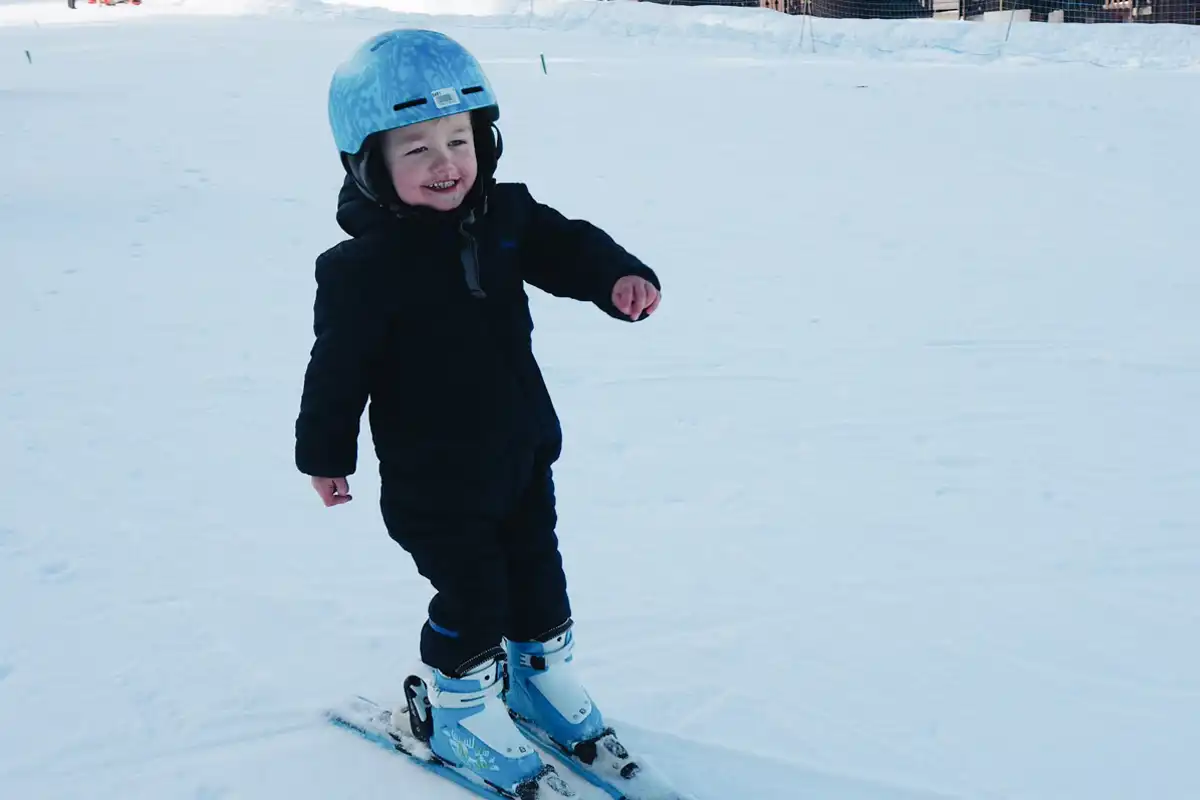 Family skiing in Valmorel: Their child enjoying skiing on his own