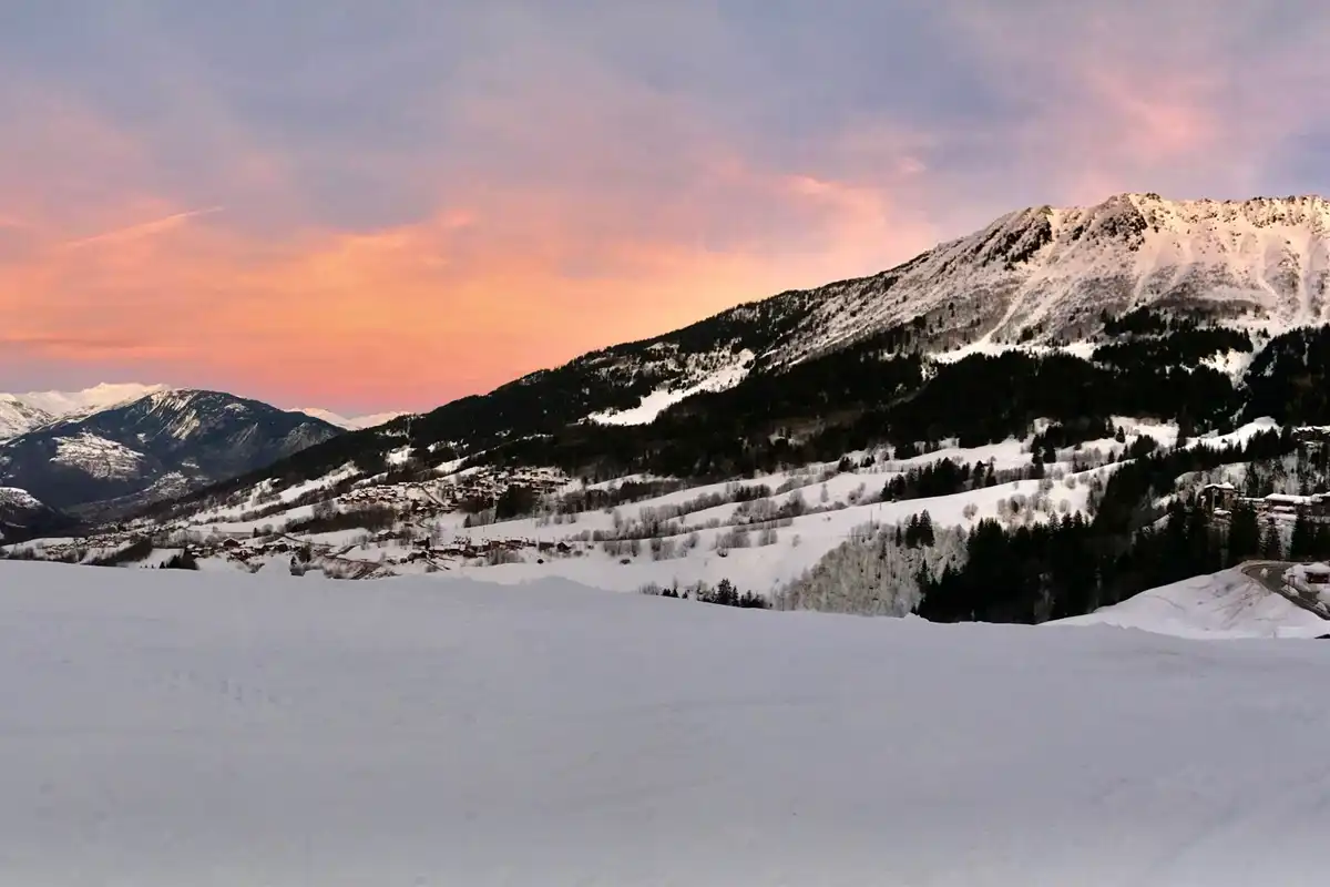 Family skiing in Valmorel: The sunsetting behind the mountain