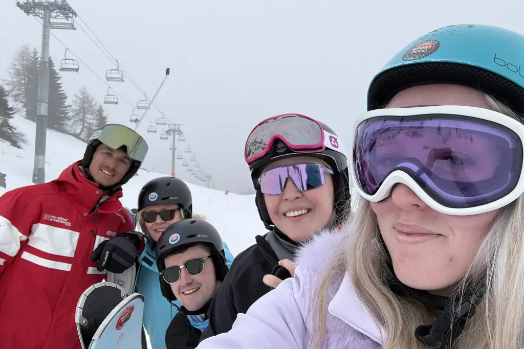 Becca and colleagues in ski lesson.webp
