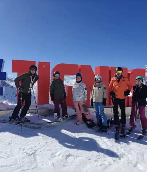 Peak Retreats Team Members By The Tignes Signs