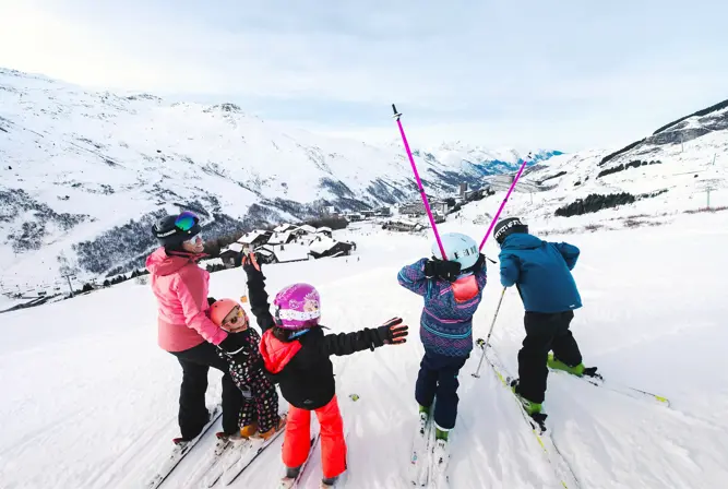 Les Menuires ski resort family skiing above resort David_ANDRE