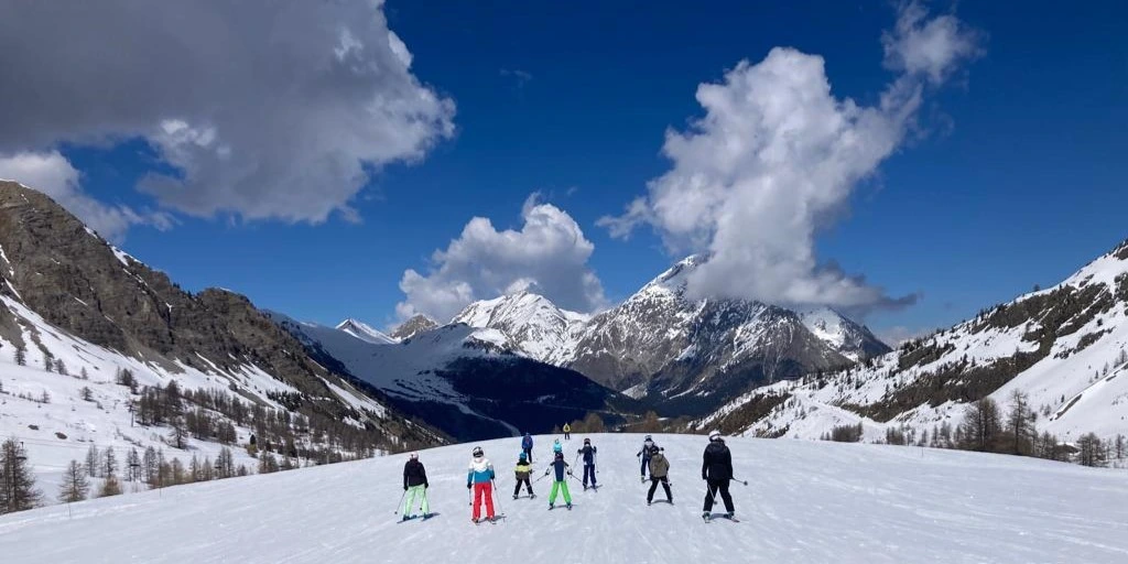 Mixed family group of skiers in Montgenevre, French Alps